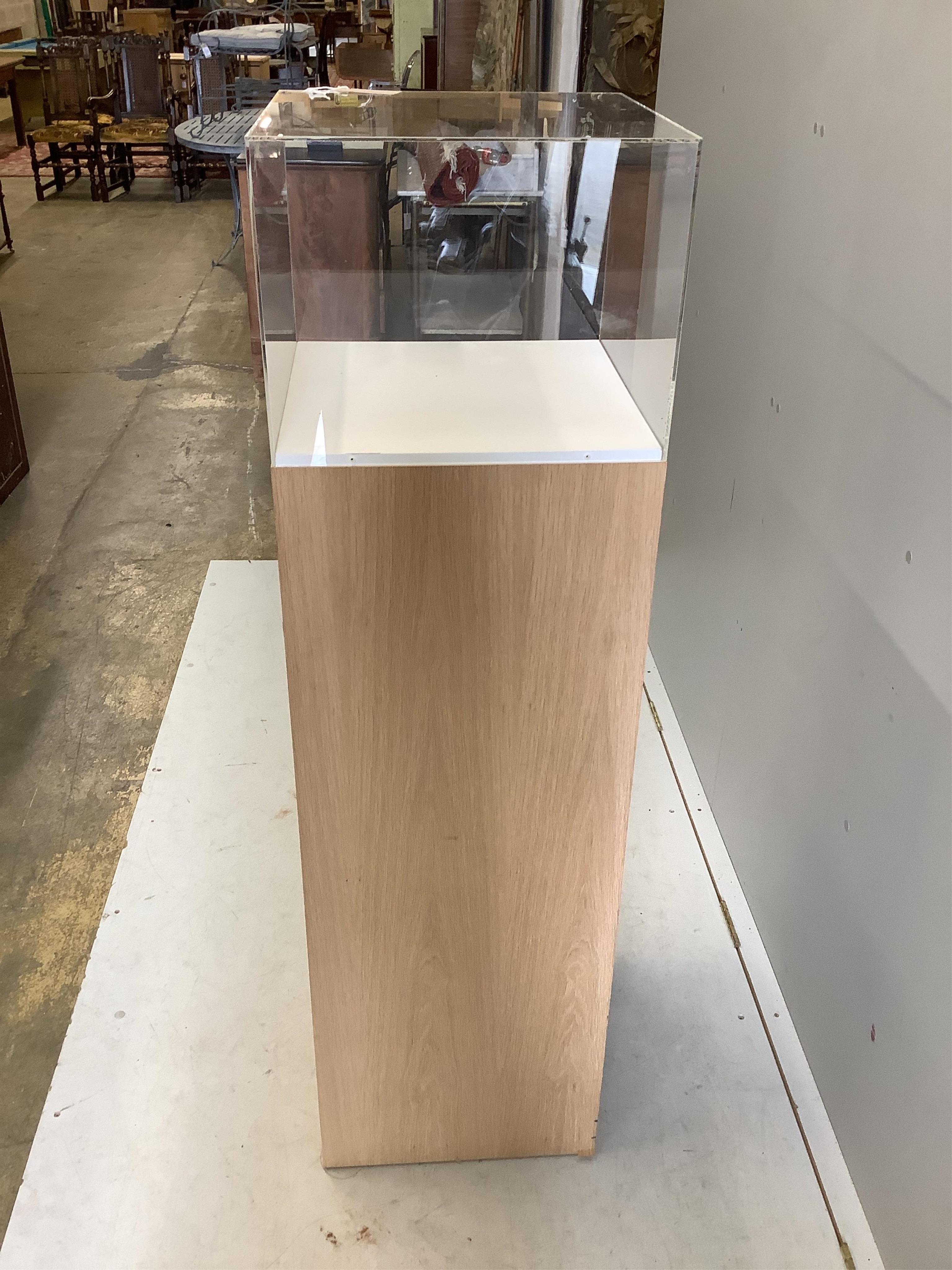 Three oak and perspex display plinths, largest height 145cm. Condition - fair